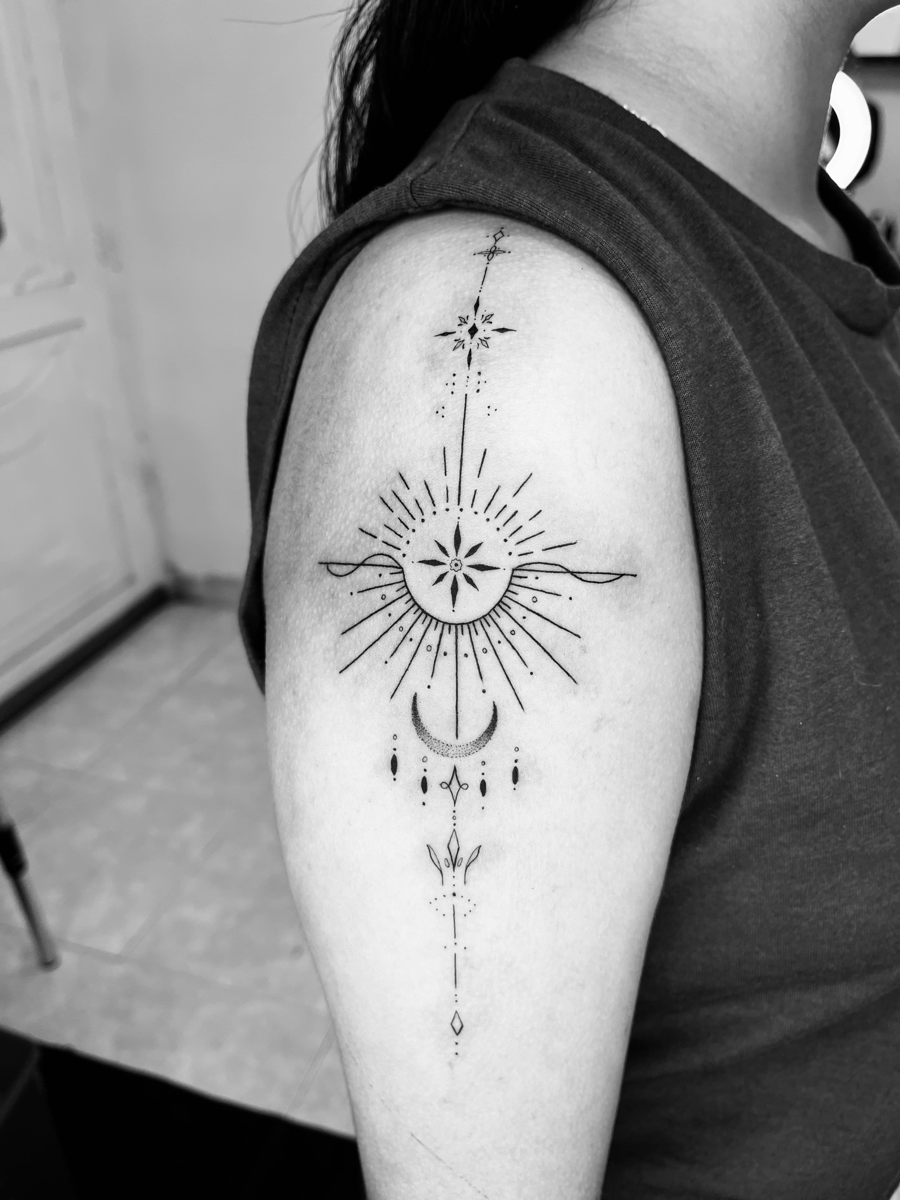 Celestial upper arm tattoo