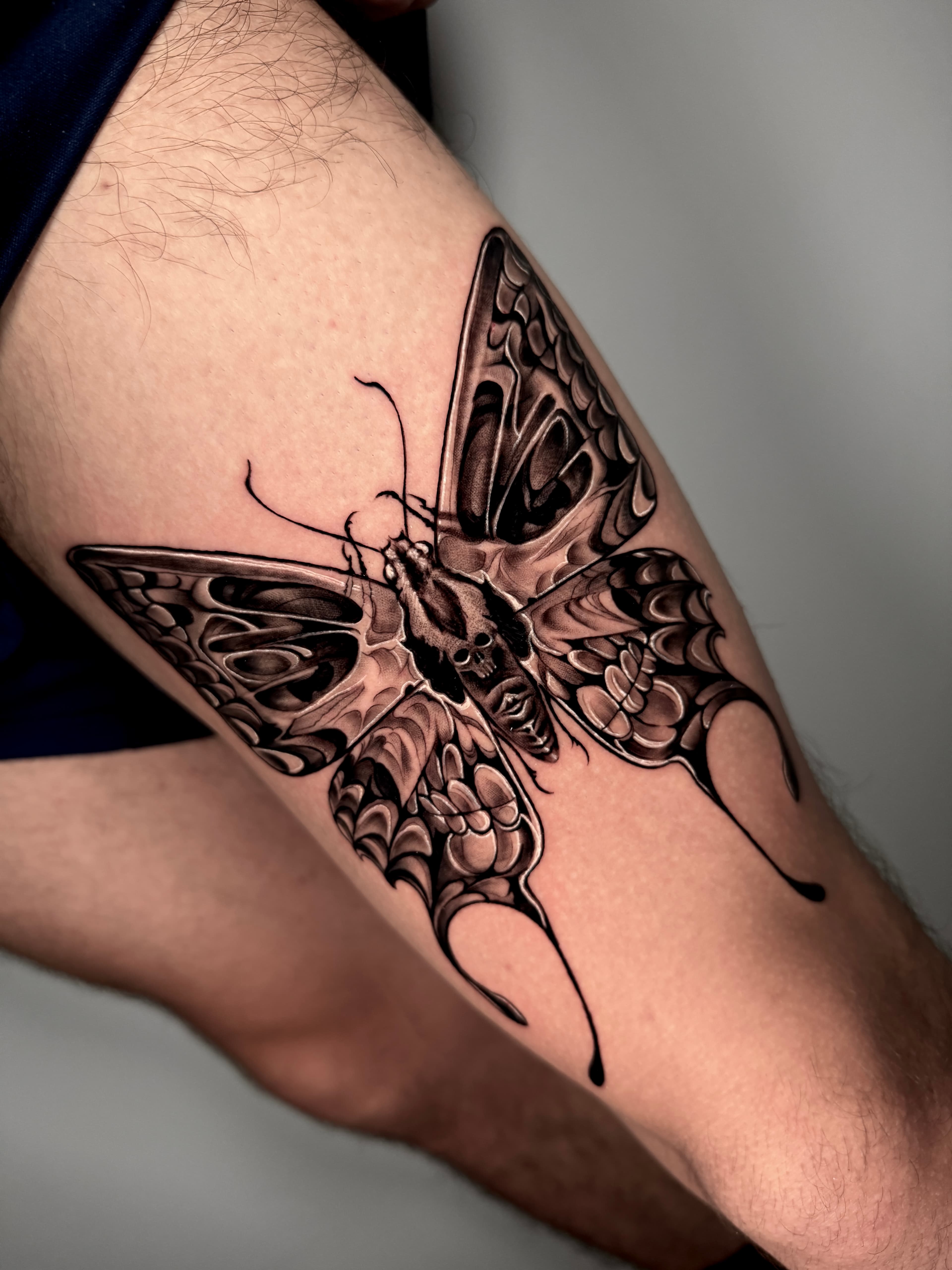 Thigh moth tattoo